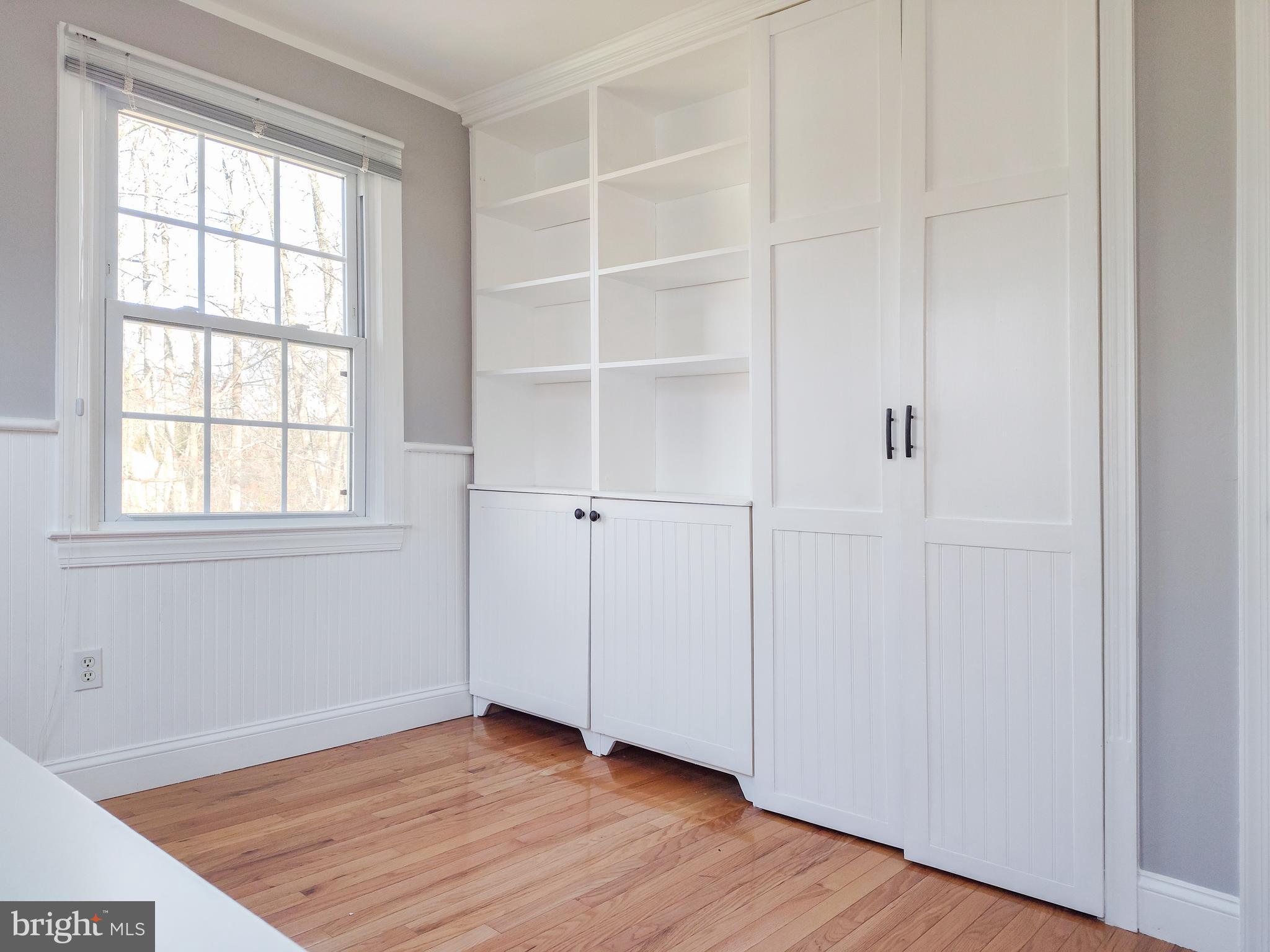 9513 Cherry Oak Court Burke, VA 22015 - Photo 25 of 40 an empty room with wooden floor closet and windows
