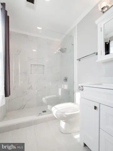 a view of an empty room and wooden floor