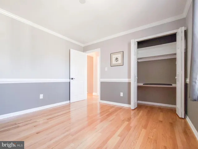 a view of walk in closet with wooden floor