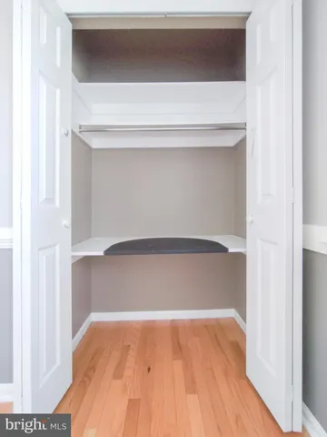 an empty room with windows and chandelier