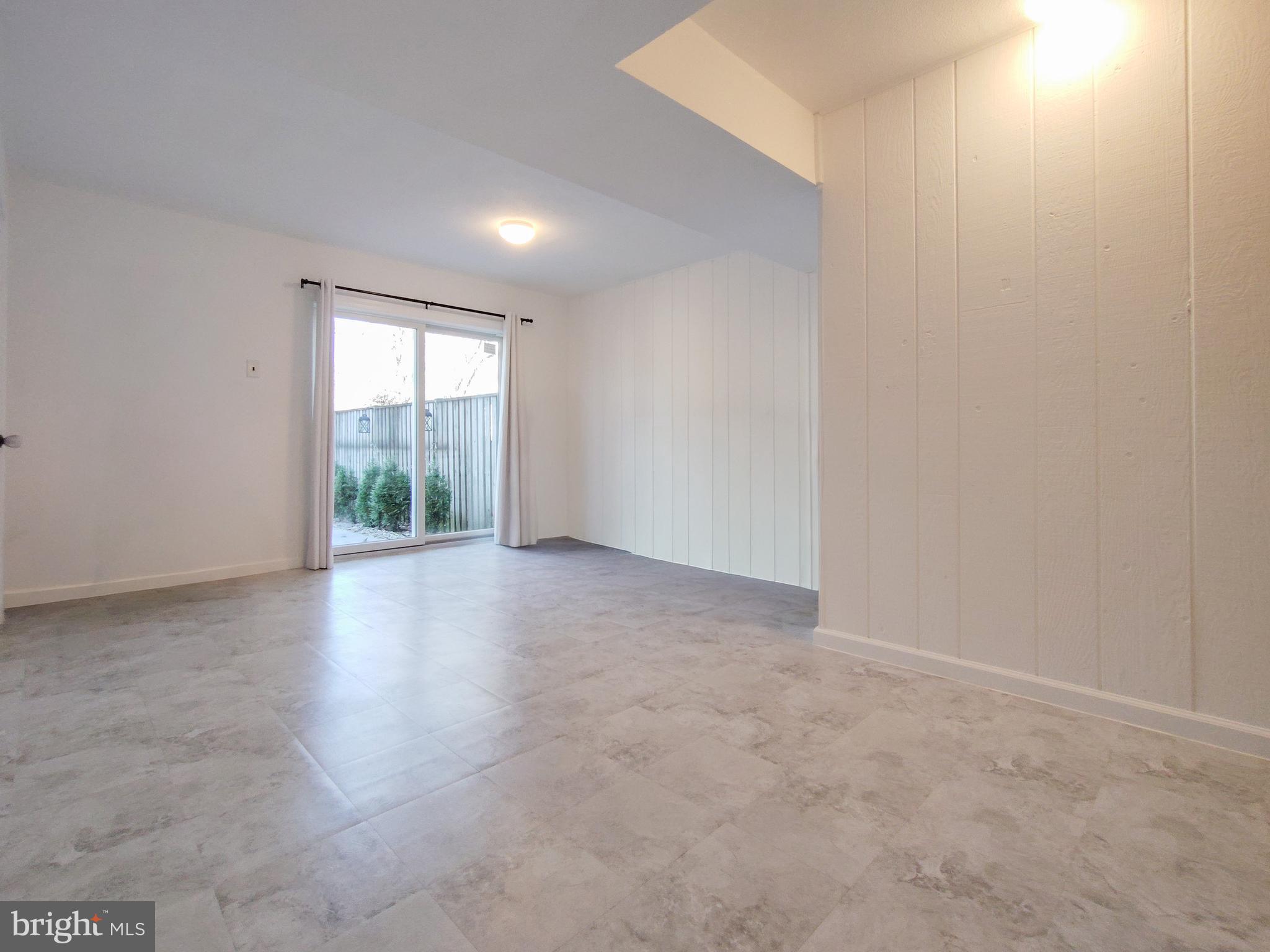 9513 Cherry Oak Court Burke, VA 22015 - Photo 31 of 40 an empty room with windows and chandelier