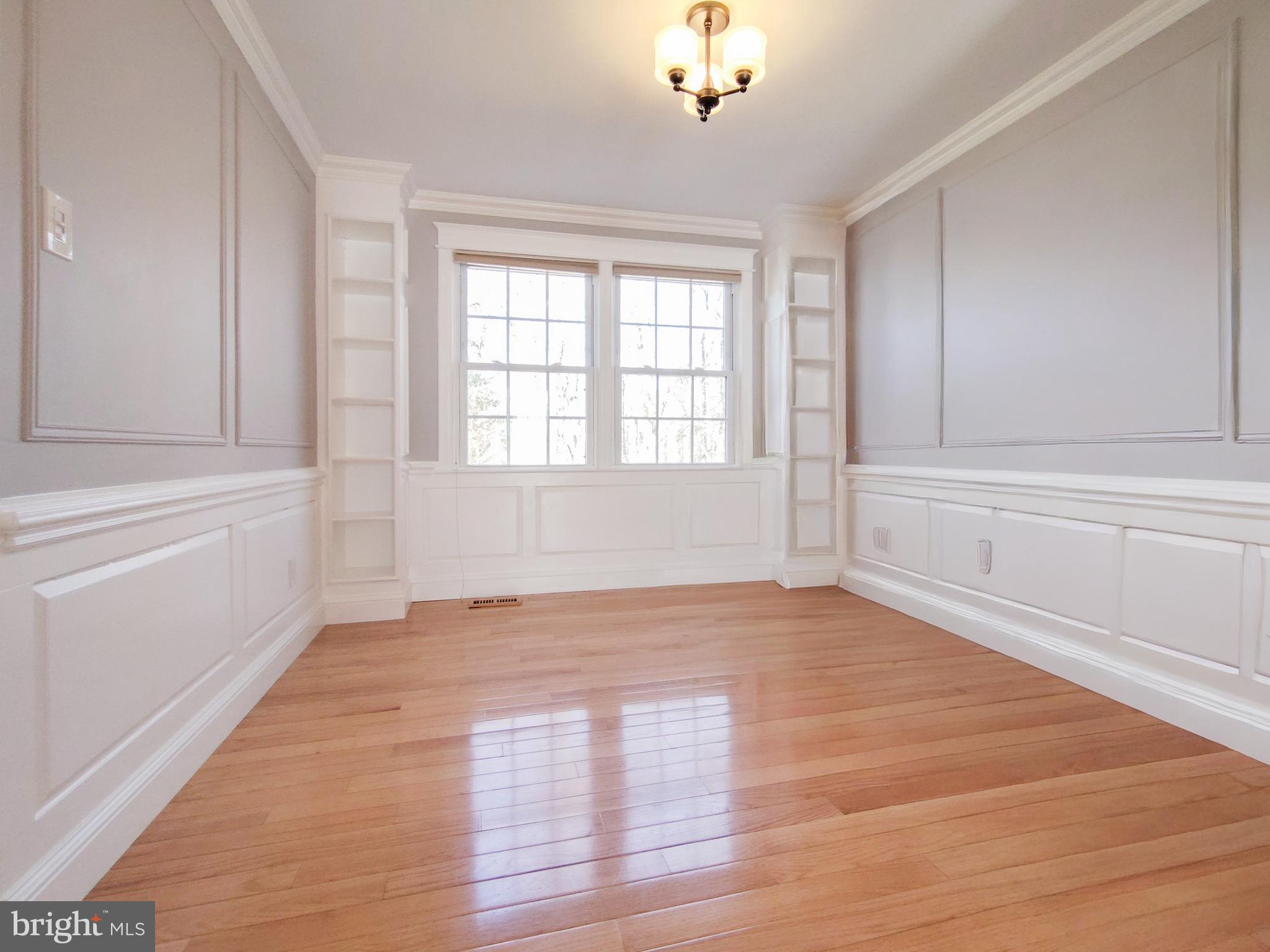 9513 Cherry Oak Court Burke, VA 22015 - Photo 6 of 40 a view of an empty room with a window and wooden floor