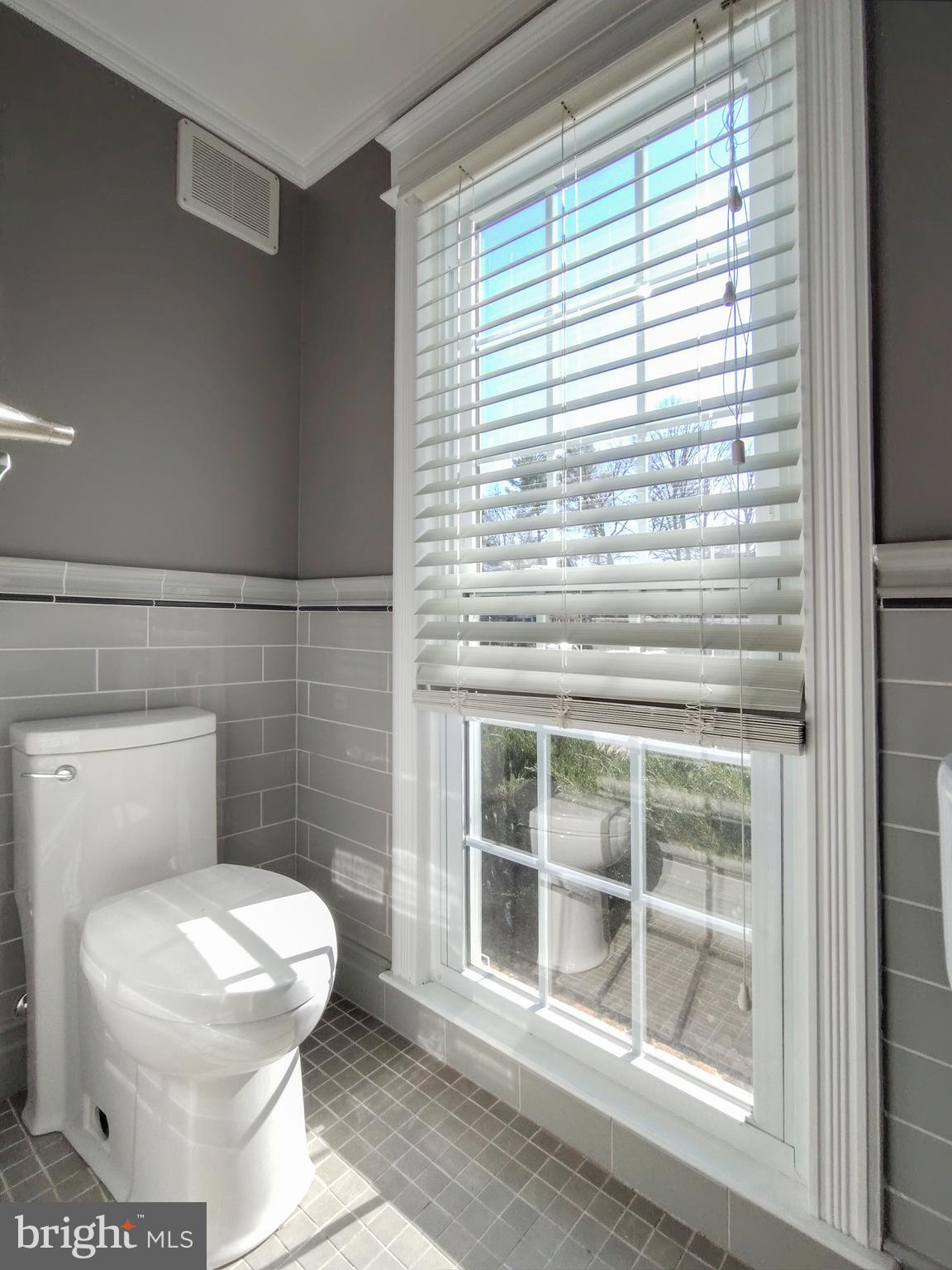 9513 Cherry Oak Court Burke, VA 22015 - Photo 8 of 40 a bathroom with a toilet a sink and shower