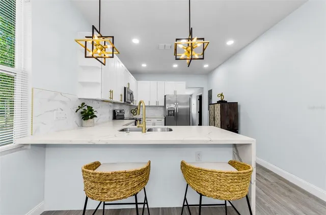 a kitchen with a table and chairs