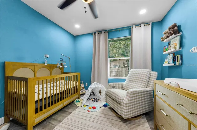 a bedroom with furniture and a large window
