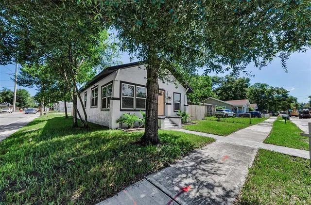 a front view of a house with yard and green space