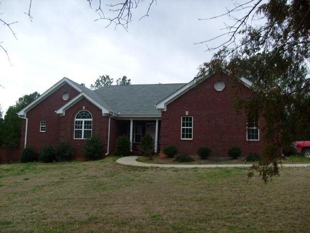 1241 Shepherd Road Madison, GA 30650 - Photo 1 of 1 a front view of house with backyard and trees