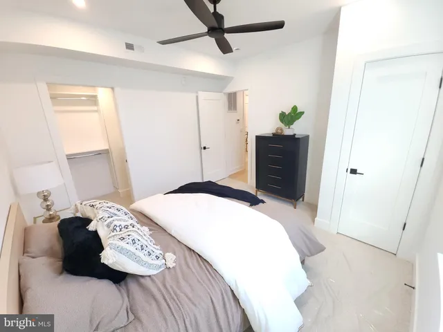 a bedroom with a bed and a dresser