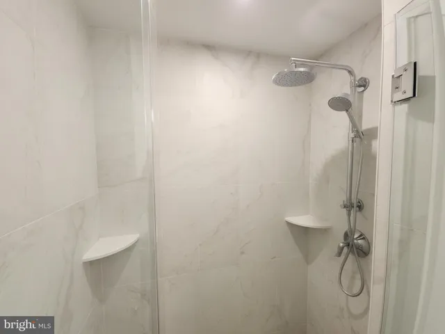a bathroom with a glass shower door