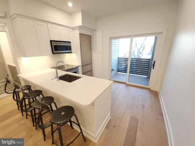 a kitchen that has a table and chairs in it