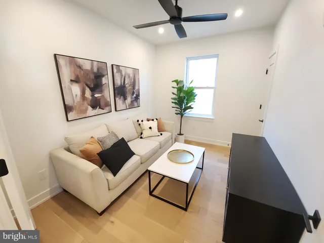 a living room with furniture and a potted plant