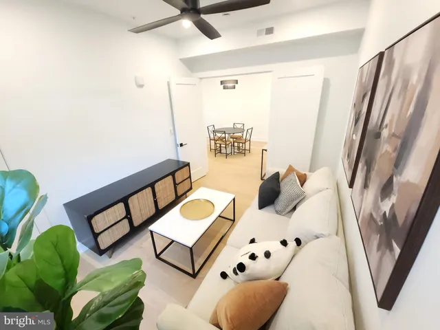 a bedroom with furniture and a large window