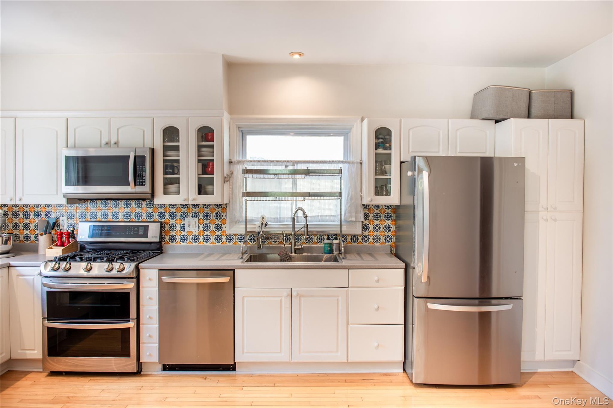 350 Smith Street Peekskill, NY 10566 - Photo 16 of 32 a kitchen with stainless steel appliances a refrigerator sink and microwave