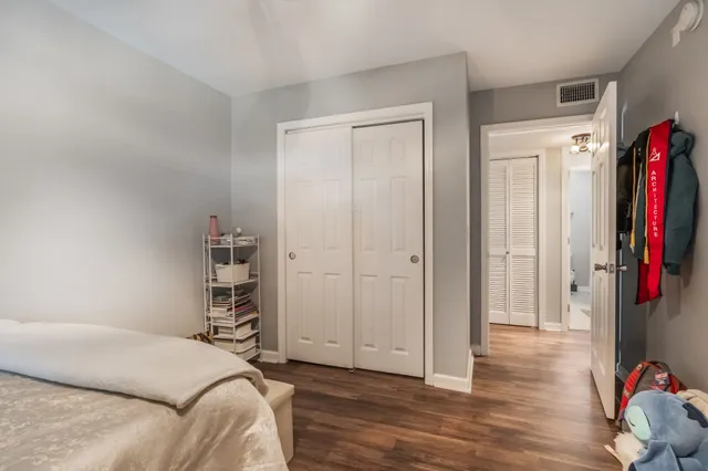 a bedroom with a bed and a closet