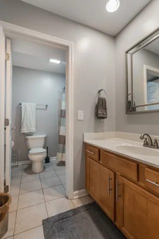 a spacious bathroom with a toilet sink and mirror