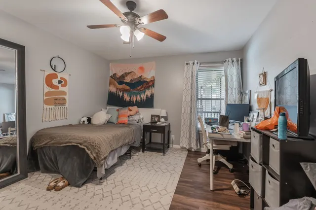 a bedroom with a bed and a flat screen tv