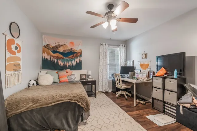 a bedroom with a bed and a chandelier