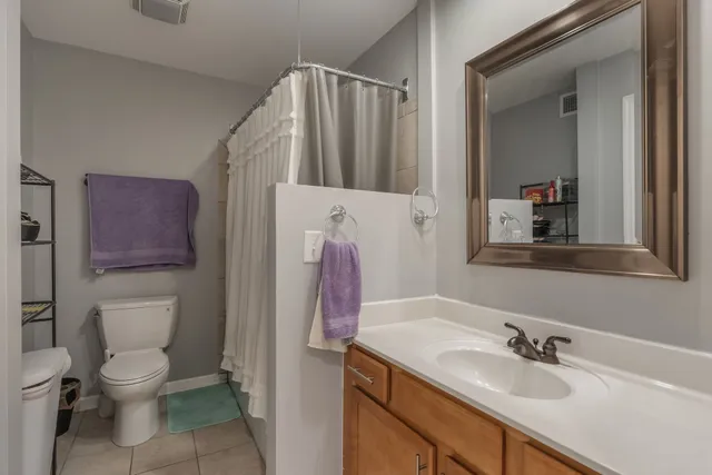 a bathroom with a sink vanity mirror and toilet
