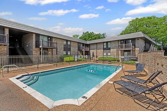 a view of a house with swimming pool and porch