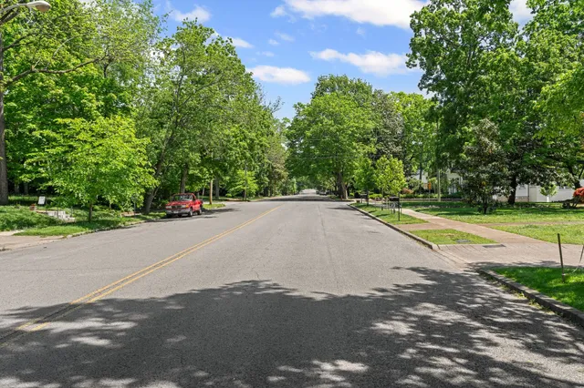 a view of a swimming pool with a yard