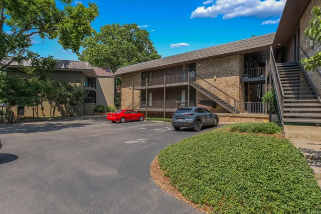 a car parked in front of house with a yard
