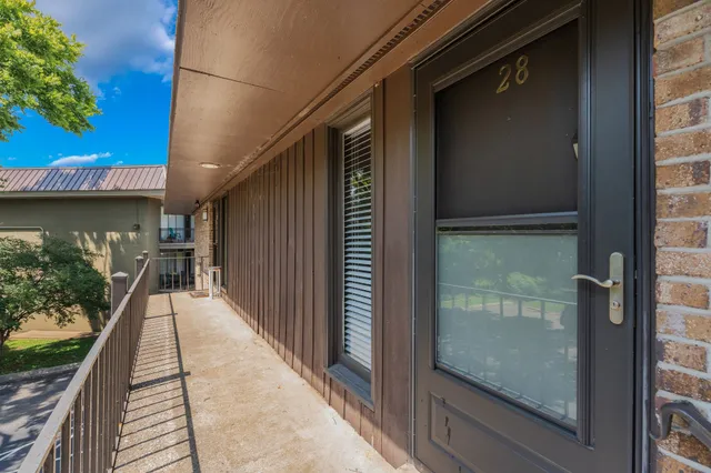 a view of balcony with floor to ceiling windows and wooden floor