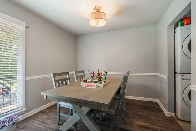 a view of a dining room with furniture and wooden floor