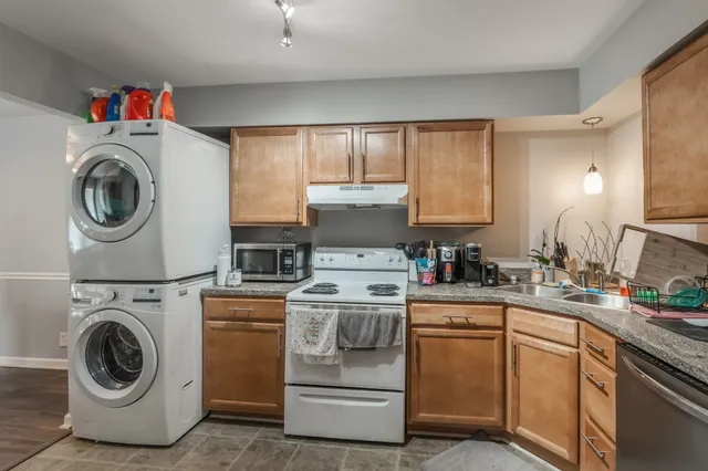 a kitchen with a stove top oven sink and cabinets