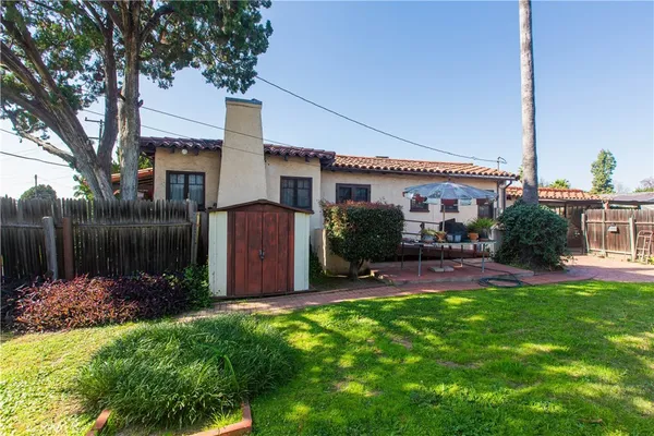 a front view of a house with garden and yard