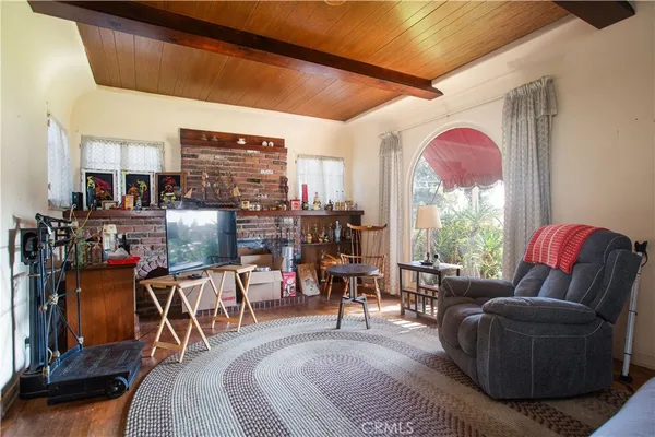 a living room with furniture a flat screen tv and a large window