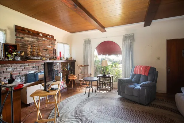 a living room with furniture a fireplace and a large window
