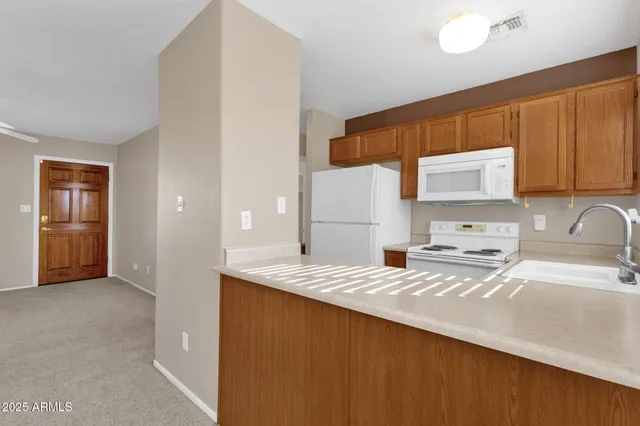 a kitchen with a sink a stove and refrigerator