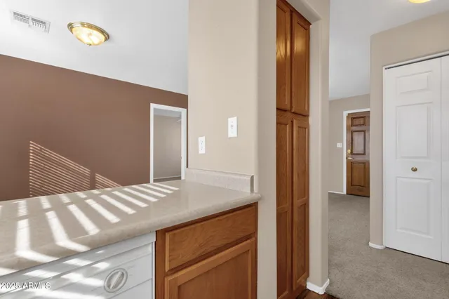 a en suite bathroom with a granite countertop sink and a mirror
