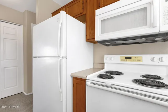 a white refrigerator freezer sitting inside of a kitchen