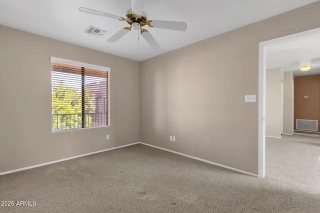 a view of room with a ceiling fan and window