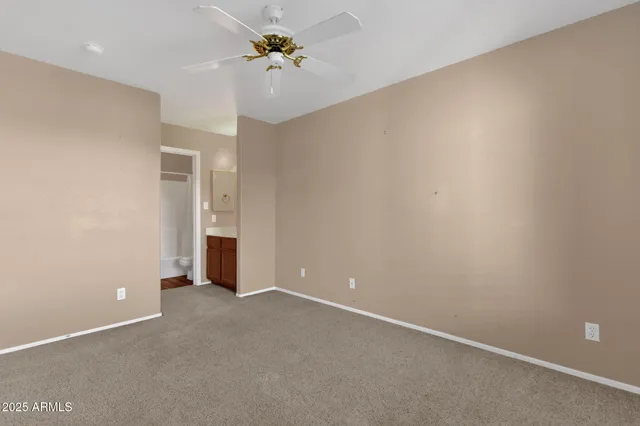 an empty room with a empty space and a ceiling fan