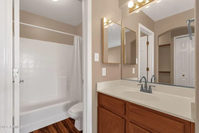 a bathroom with a bathtub shower sink vanity and a mirror