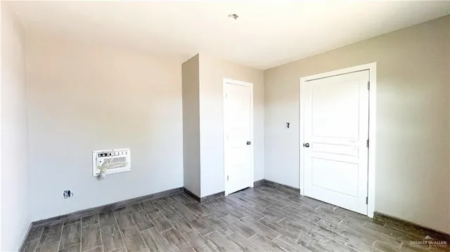 a view of an empty room and wooden floor