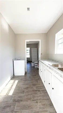 a view of a kitchen with sink cabinets and a window