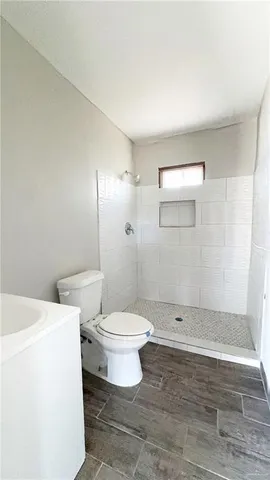 a bathroom with a toilet a sink and shower
