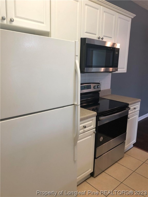 649 Brandermill Road, Unit 203 Fayetteville, NC 28314 - Photo 11 of 26 a kitchen with a refrigerator and a microwave