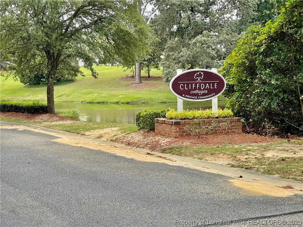 649 Brandermill Road, Unit 203 Fayetteville, NC 28314 - Photo 21 of 26 a view of a street with a bench and trees around