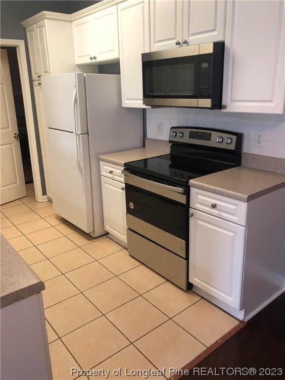 649 Brandermill Road, Unit 203 Fayetteville, NC 28314 - Photo 10 of 26 a kitchen with a stove and a refrigerator