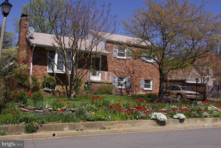 6015 22nd Road North Arlington, VA 22205 - Photo 1 of 16 a front view of a house with a yard and potted plants