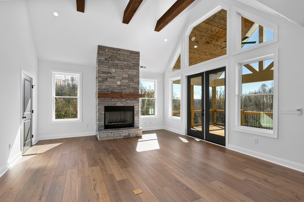 10 West Hawks Nest Road Blairsville, GA 30512 - Photo 13 of 40 an empty room with floor to ceiling windows and fireplace