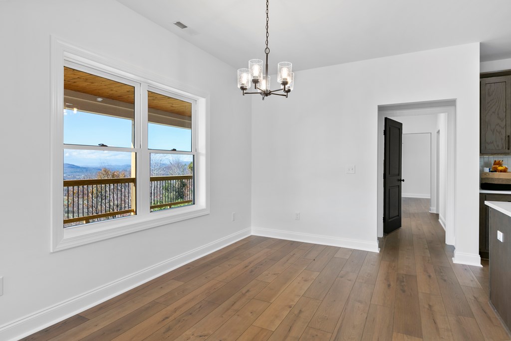 10 West Hawks Nest Road Blairsville, GA 30512 - Photo 15 of 40 a view of empty room with wooden floor and fan
