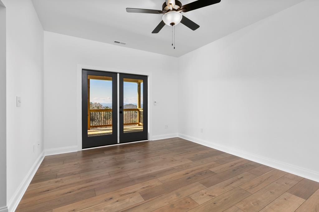 10 West Hawks Nest Road Blairsville, GA 30512 - Photo 18 of 40 a view of an empty room with a window and wooden floor