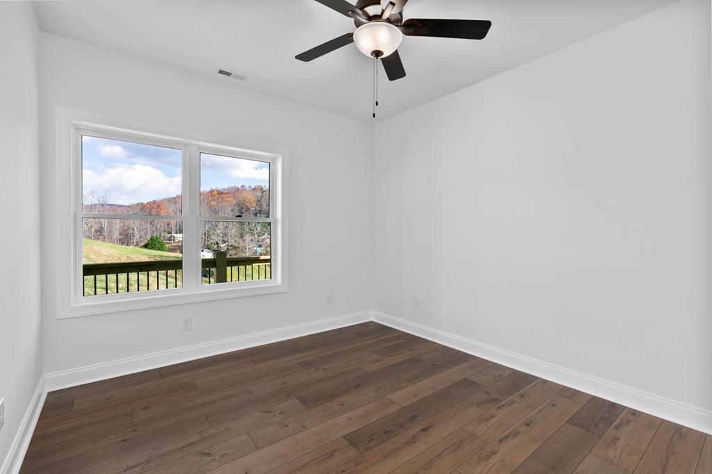 10 West Hawks Nest Road Blairsville, GA 30512 - Photo 20 of 40 a view of an empty room with wooden floor and a window