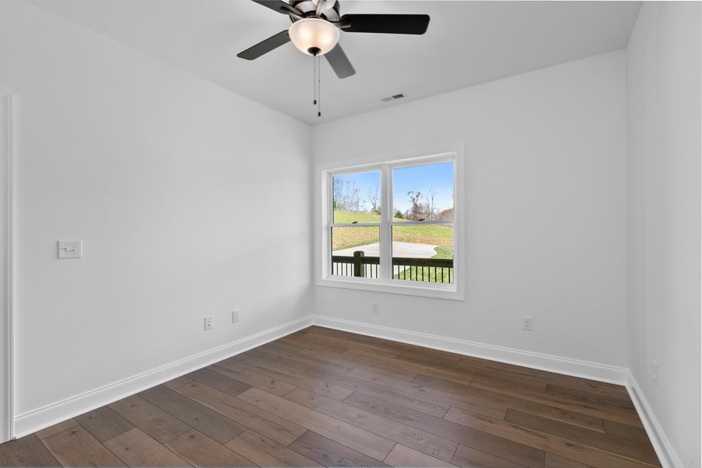 10 West Hawks Nest Road Blairsville, GA 30512 - Photo 21 of 40 an empty room with wooden floor and windows
