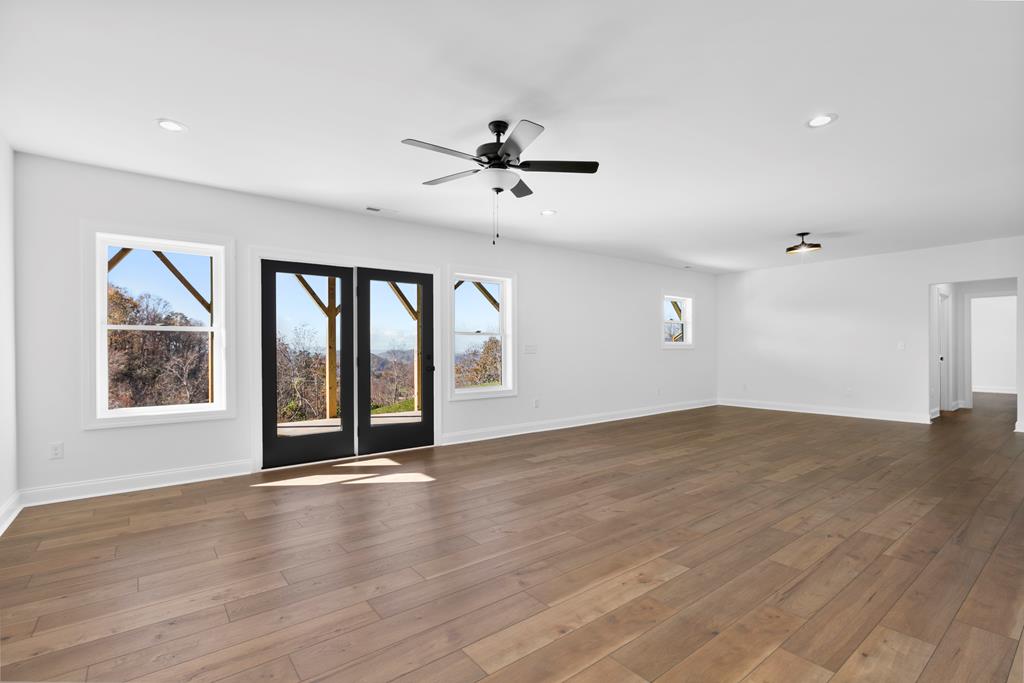10 West Hawks Nest Road Blairsville, GA 30512 - Photo 23 of 40 a view of an empty room with a window and wooden floor
